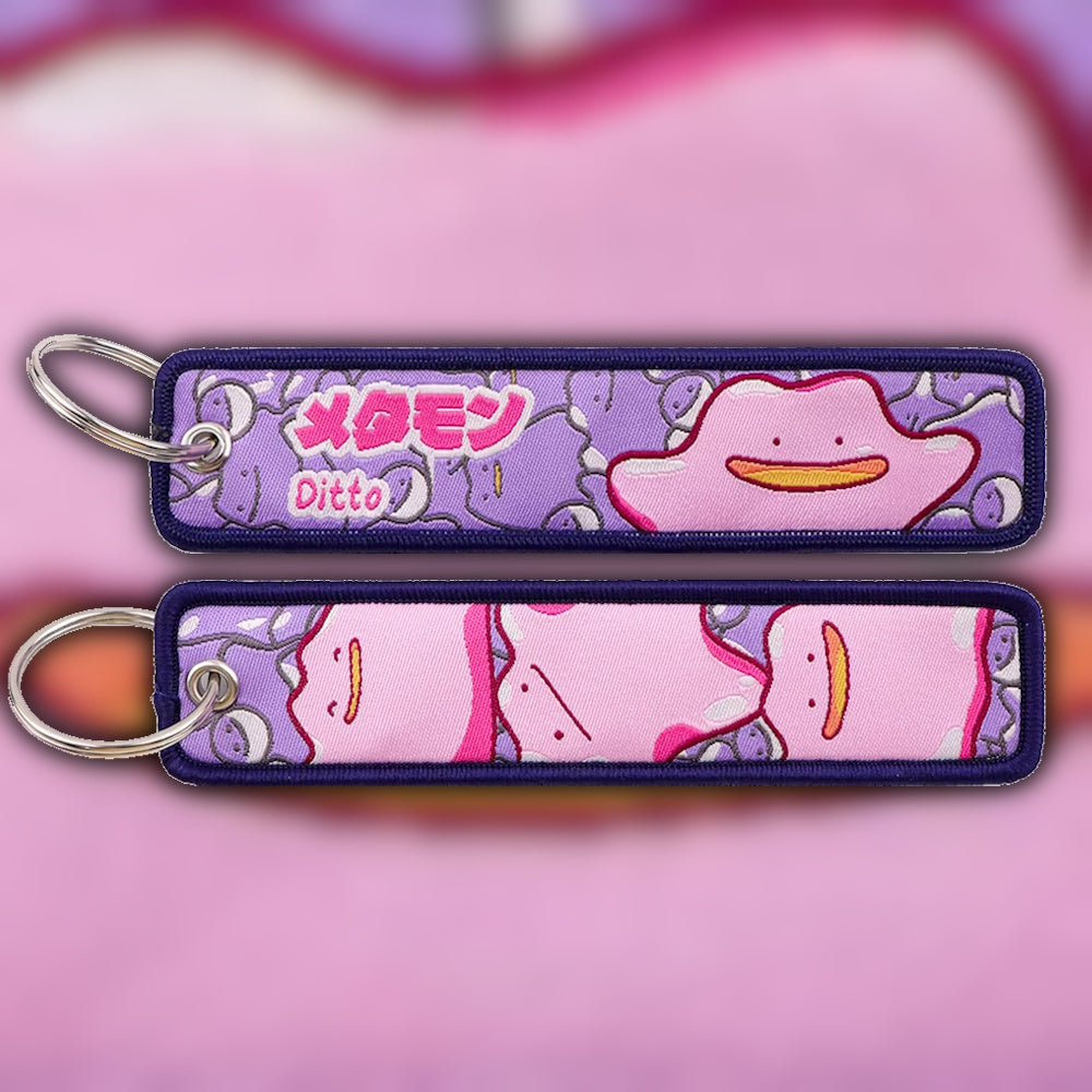 Ditto purple woven fabric keytag attached to metal keyring featuring embroidered Ditto artwork